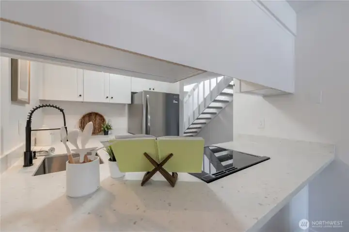 Kitchen breakfast bar opens to the living and dining areas, creating a seamless flow for everyday living and entertaining.
