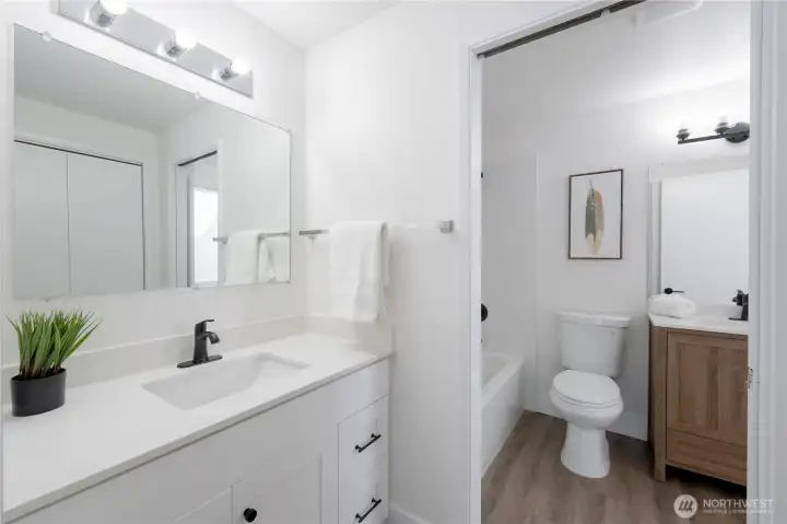 Private vanity adjoining the primary bedroom offering ample cabinetry, counter top space, and extra storage closest across from primary vanity (not in photo)