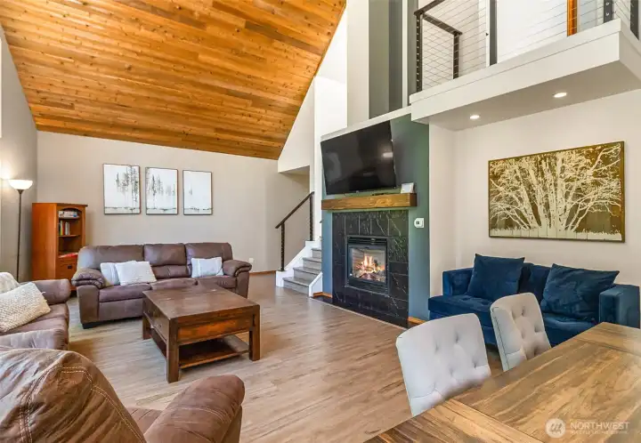 The space includes a gas fireplace for cozy evening. Note the second floor balcony.