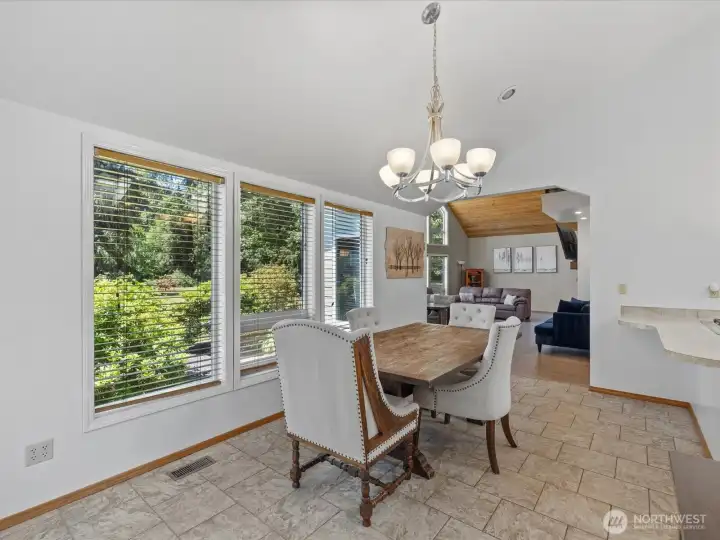 The holiday sized dining room brings in the view of the beautiful grounds.