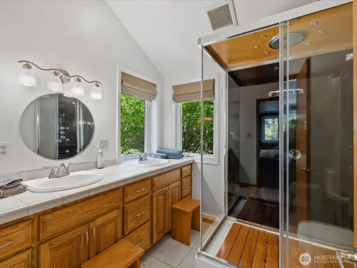 The luxurious primary bath features a double sink vanity and gorgeous walk-in shower.