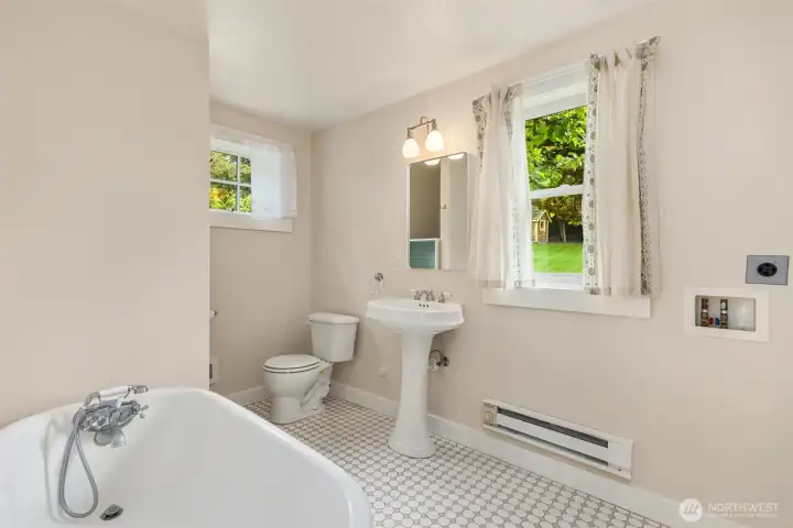 ...in addition to a charming bathroom with laundry hookup.