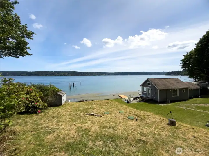 The view from the property captures everything that makes waterfront living so special—calm waters, sandy shoreline, and endless sky. Picture gathering with friends, enjoying a picnic by the water, or watching the sunrise paint Mt. Rainier in the distance from the future home you'll create here.