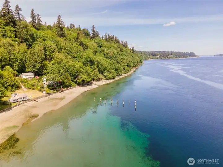 The beauty of the surrounding coastline is on full display from above. This exceptional property offers 48 feet of low-bank waterfront, a sandy shoreline, and sweeping views across Colvos Passage. Watch the tides shift, spot whales, seals, and eagles throughout the seasons, and enjoy the ever-changing scenery that makes waterfront living along Puget Sound so special.