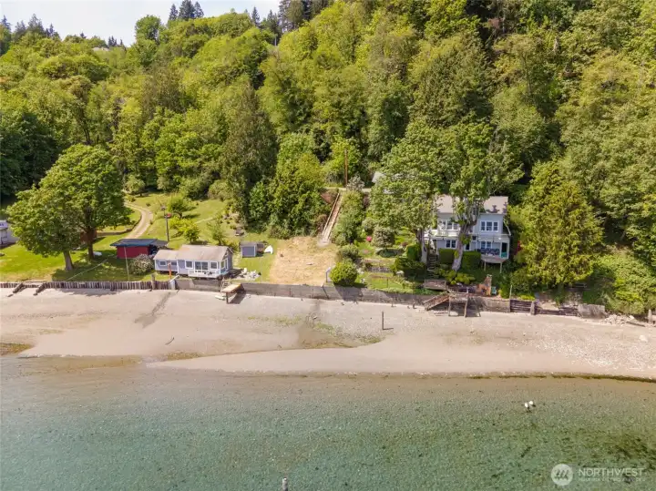 From the water, the property's setting truly shines. Tucked between established waterfront homes and backed by mature trees, this is a rare opportunity to build along one of Gig Harbor's most scenic stretches of shoreline while remaining just 13 minutes from shopping, amenities, and Highway 16.