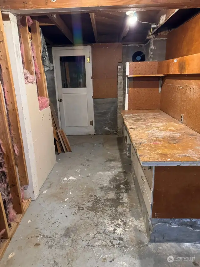 Basement work bench and door to 2nd staircase