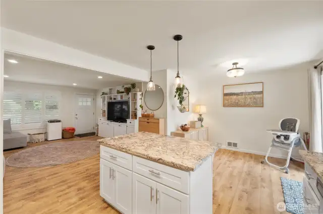 Updated lighting graces the island & adjacent dining room
