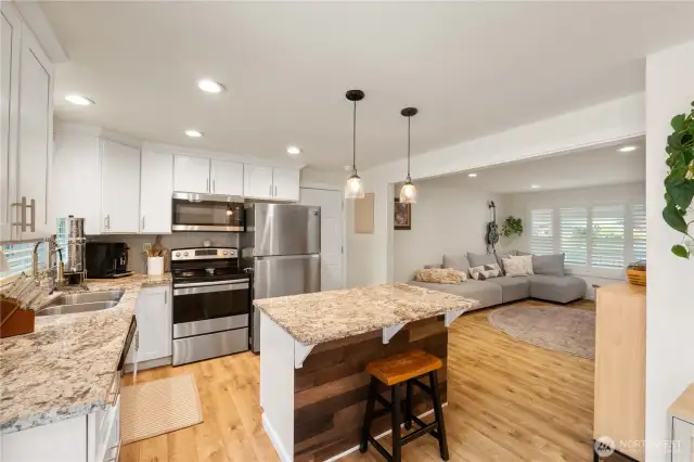 The inlaid stainless sink, upgraded hands free faucet & wood accents on the island are just a few more features of this functional and stunning kitchen