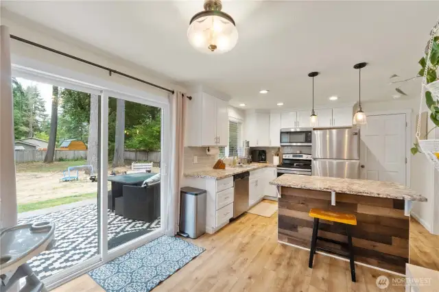 The large slider provides cheery light & leads to your deck where you can enjoy outdoor dining with a BBQ & relax with a beverage