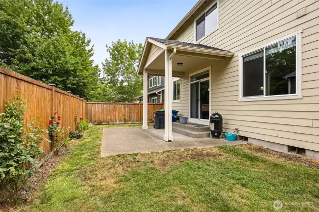 Enjoy the low-maintenance lifestyle with this backyard that lets you spend more time having fun and less time working. The covered patio near the slider keeps your BBQ plans rain-free, and the uncovered area gives you space for seating or outdoor activities. Rose bushes and easy-to-care-for plantings along the fence add beauty without the effort. The lawn extends right up to the house, offering a manageable area with room for a trampoline or whatever else you want to make the space your own.