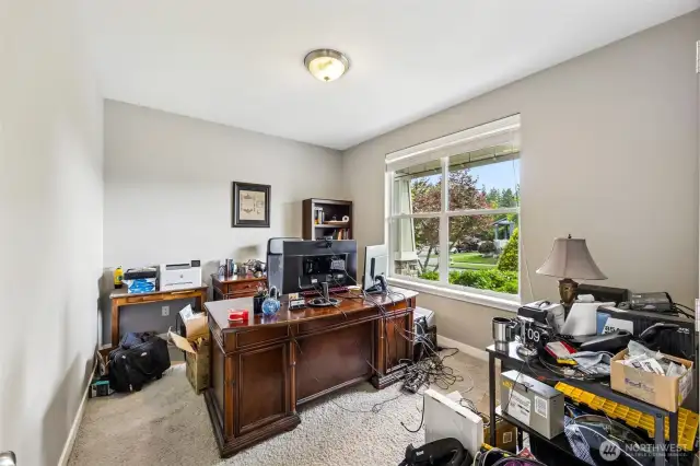 If you’ve been searching for the perfect remote work setup, this office with French doors delivers. Located on the main floor, it features neutral-toned walls, fresh white trim, and a big picture window that lets in natural light while offering a view of the front porch. The soft carpeting and wide slat blinds are the finishing touches that make this space feel calm and organized.