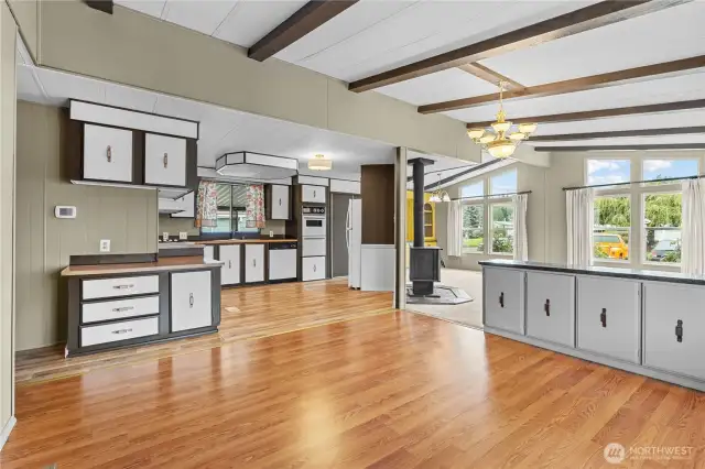 Another angle of the bright living space with kitchen and seating/living/dining area