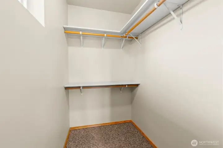 Closet featuring hanging storage and ample room for clothes and accessories.