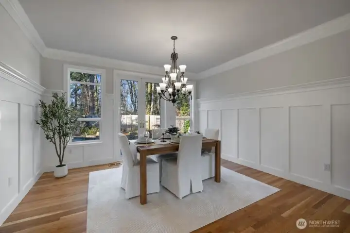 This home boasts extraordinary millwork throughout... Notice the beautiful wainscotting, and French doors that lead to the huge outdoor patio!