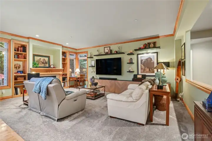 Inviting living room complete with gas fireplace, built-ins, and thoughtfully positioned windows.