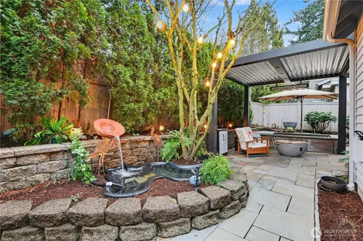 Backyard also features a charming pond surrounded by mature landscaping.