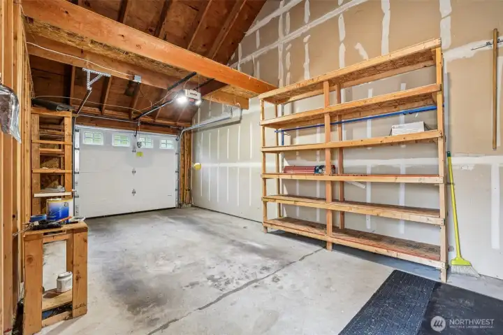 Garage with loft storage and built in shelves
