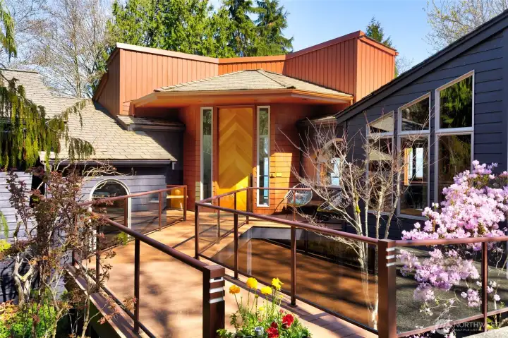 Modern waterfront home entry with wood accents