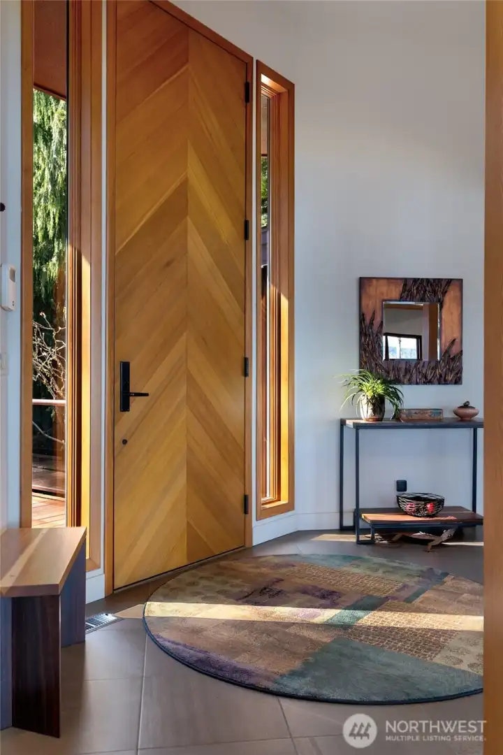 Stylish foyer with custom wood front door