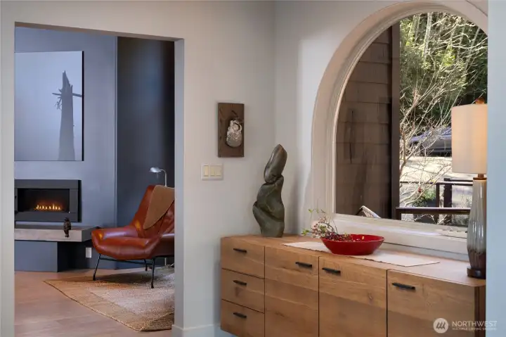 Bright entryway with wood door and modern decor