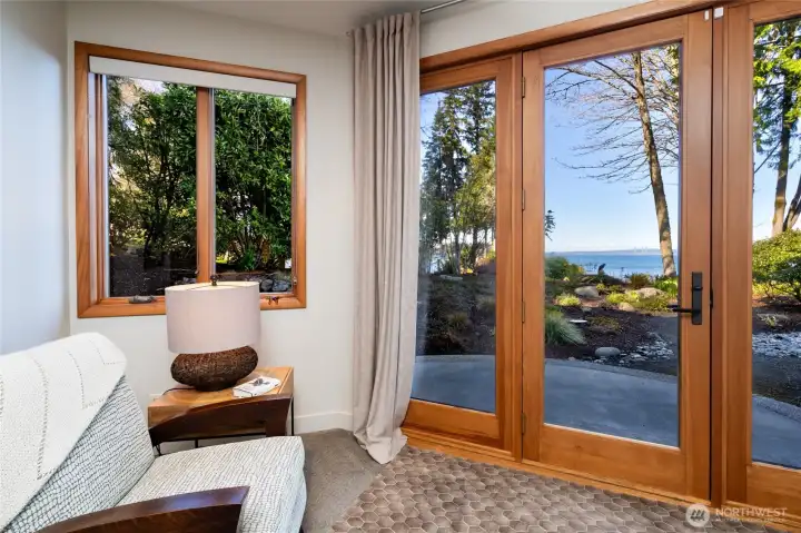 Bright sitting room with garden and water views