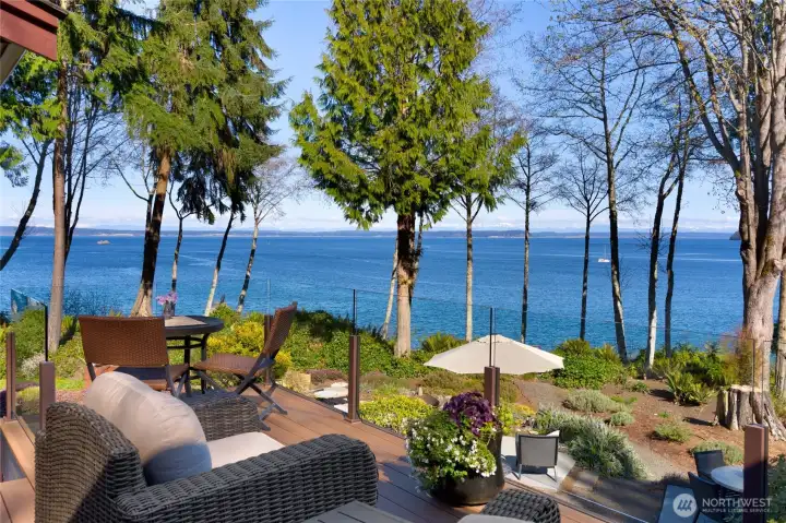 Deck seating overlooking landscaped waterfront yard