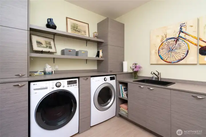 Modern laundry room with cabinets and storage
