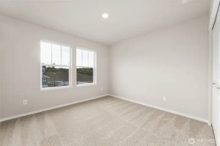 Well-sized secondary bedroom. Photos are representative only and may display different color packages and/or upgrades. Well-sized secondary bedroom. Photos are representative only and may display different color packages and/or upgrades.
