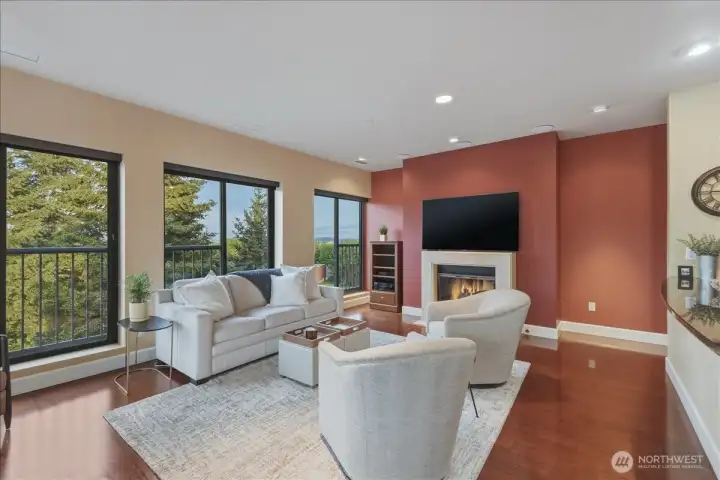 Living Room, hardwood floors, high ceilings, large windows, corner unit, gas fireplace
