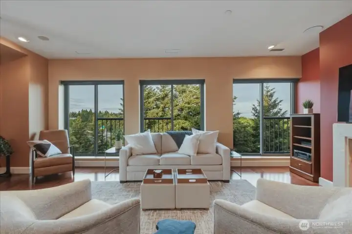 Living Room, hardwood floors, high ceilings, large windows, corner unit, gas fireplace