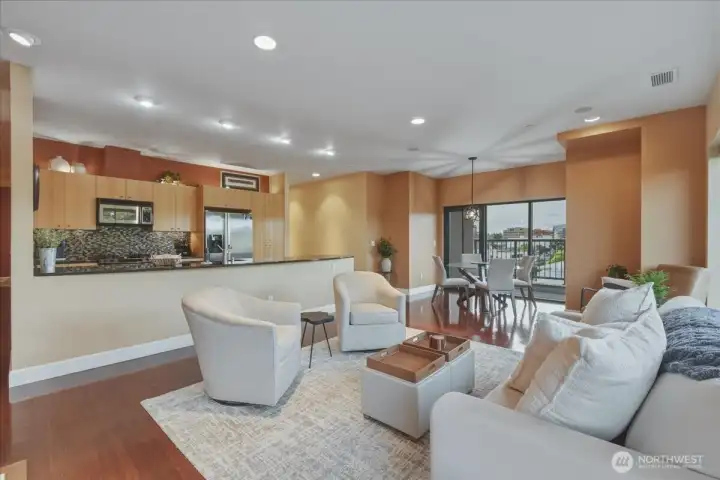 Living Room, hardwood floors, high ceilings, large windows, corner unit, gas fireplace, kitchen w/ island & granite counters