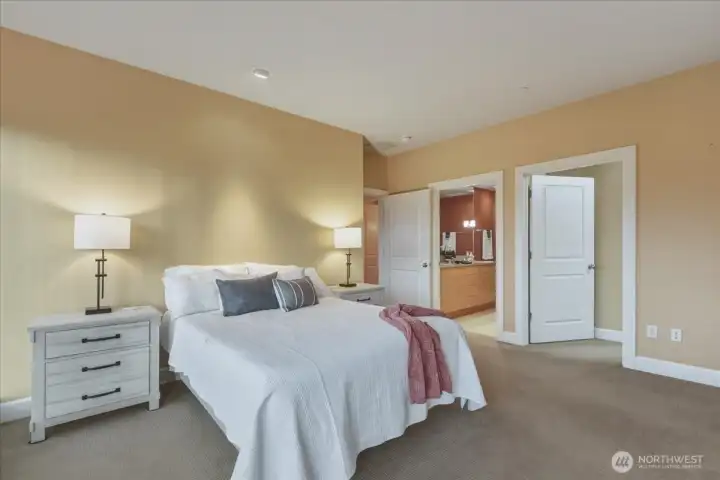 Primary suite, built-in shelves, ensuite bath, double vanity, walk-in tile shower, walk-in closet