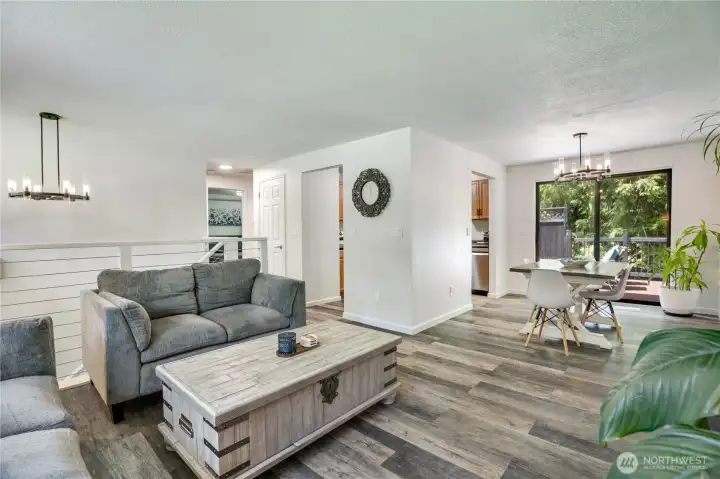 Designed for gathering, the upper level offers an easy flow between the living room, dining area, and kitchen.