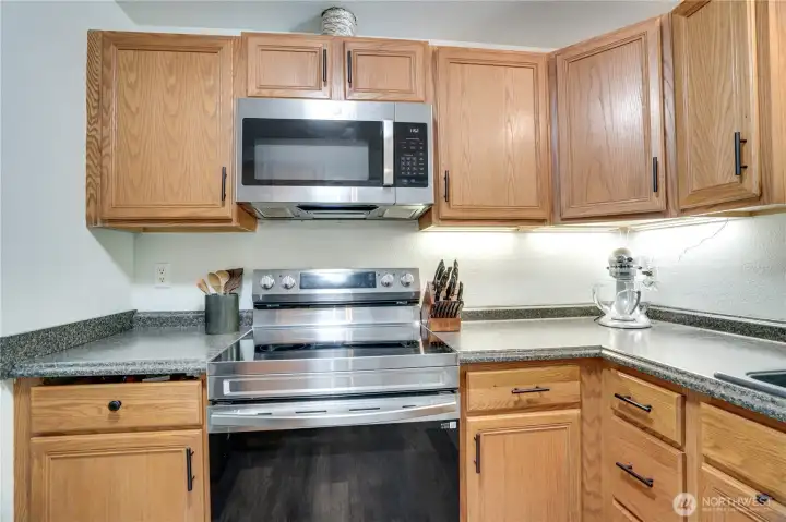 Newer stainless steel appliances all stay! This kitchen conveniently has two entrances to keep the open flow and easy access to all parts of the upper floor.