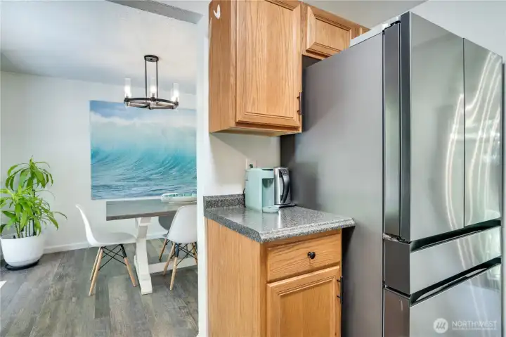 Serving meals from the kitchen to the dining room is a breeze! Note the additional cabinets and storage next to and above the refrigerator.