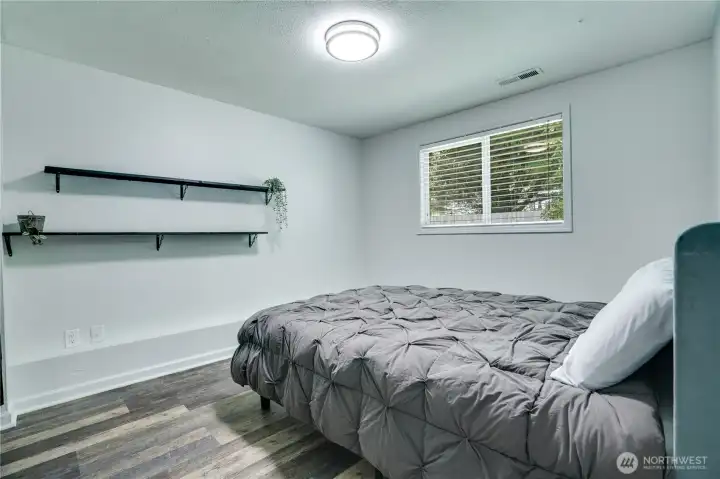 The third bedroom downstairs faces the backyard and includes an oversized closet. Fresh paint and LVP flooring give the room a clean, updated feel.