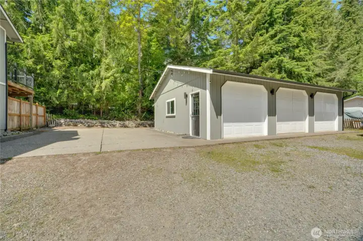 The detached shop offers more than 900 square feet of workspace and storage, including a finished room well suited for a home office, gym, creative studio, or hobby space. Additional attic storage is accessible via a pull-down ladder.
