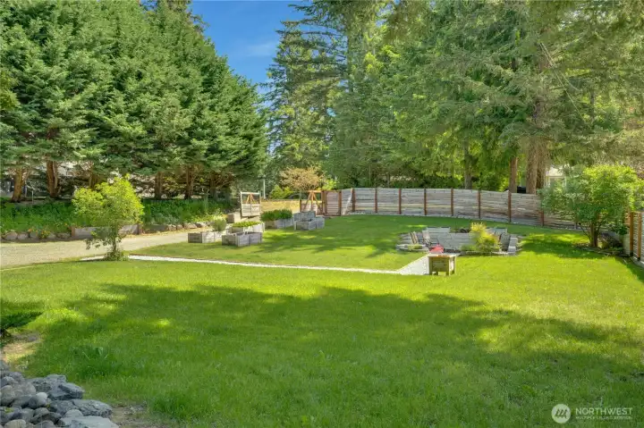 With room to spread out and enjoy the outdoors, this backyard offers ample space to gather and play.