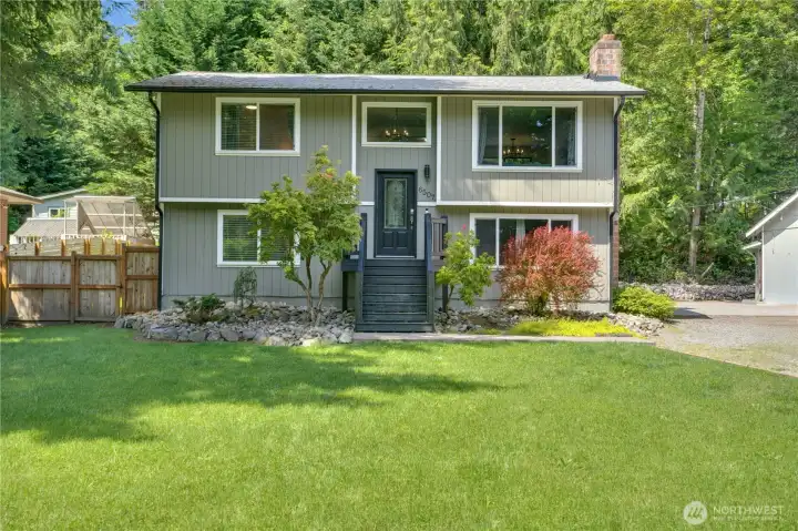 The roof and gutters were installed just a few years ago, while freshly painted front steps and updated windows contribute to the home's well-maintained appearance.