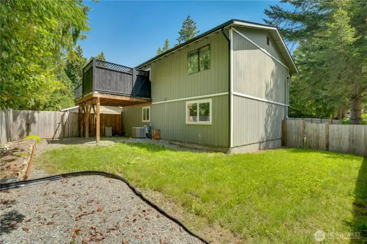 : The fully fenced backyard offers a secure outdoor space for pets, play, gardening, or everyday enjoyment.