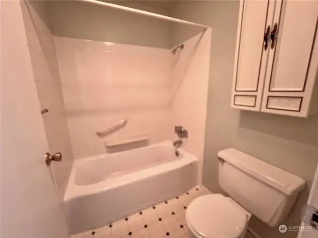 Full bath "European style" with toilet and tub in one "room" and the sink in another.