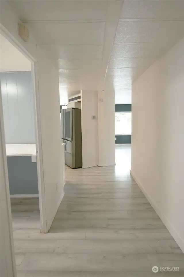 Hallway towards front of the home leading to the kitchen, living and dining room.