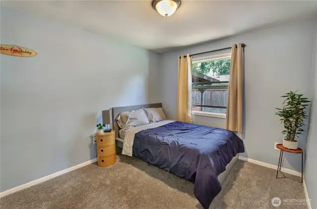 Cozy and inviting, this bedroom is the perfect retreat with soft carpet underfoot, fresh paint, and a large window that fills the space with natural light. Peaceful vibes included.