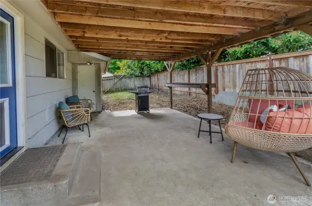 Cozy and covered! This spacious patio is ready for summer BBQs, quiet mornings with coffee, or lounging in your favorite hanging chair—rain or shine.
