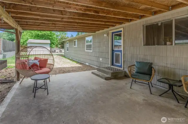 Cozy and covered! This spacious patio is ready for summer BBQs, quiet mornings with coffee, or lounging in your favorite hanging chair—rain or shine.