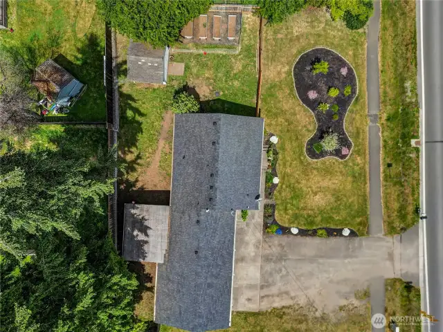 Bird’s-eye view of this beautifully maintained .25-acre lot! Fully fenced for privacy and security, with garden space, a shed, and room to roam—this outdoor setup is ready for play, pets, or planting.