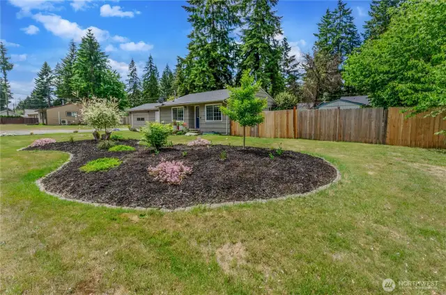 Manicured garden beds and mature landscaping add a touch of elegance to this spacious front yard. Plenty of room to play, relax, or simply enjoy your own peaceful outdoor retreat.