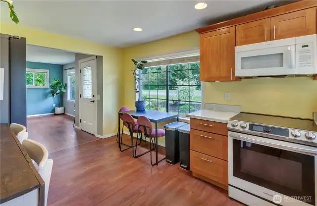 This kitchen is full of charm and functionality! Featuring sleek counters, solid cabinetry, and a cozy dining nook bathed in natural light—plus a great connection to the living space for effortless entertaining.