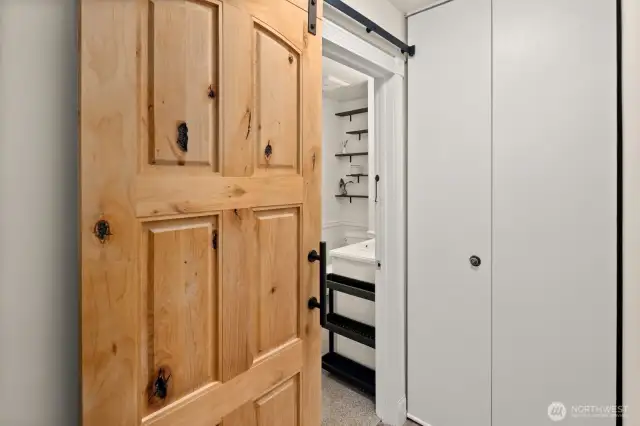 New sliding barn door saves space in the hallway.  Note the large closet to the left of bathroom entrance.