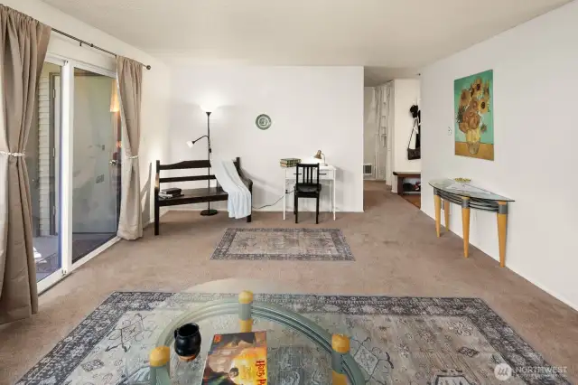 The great room features a wall of windows with a sliding door that opens onto the patio.